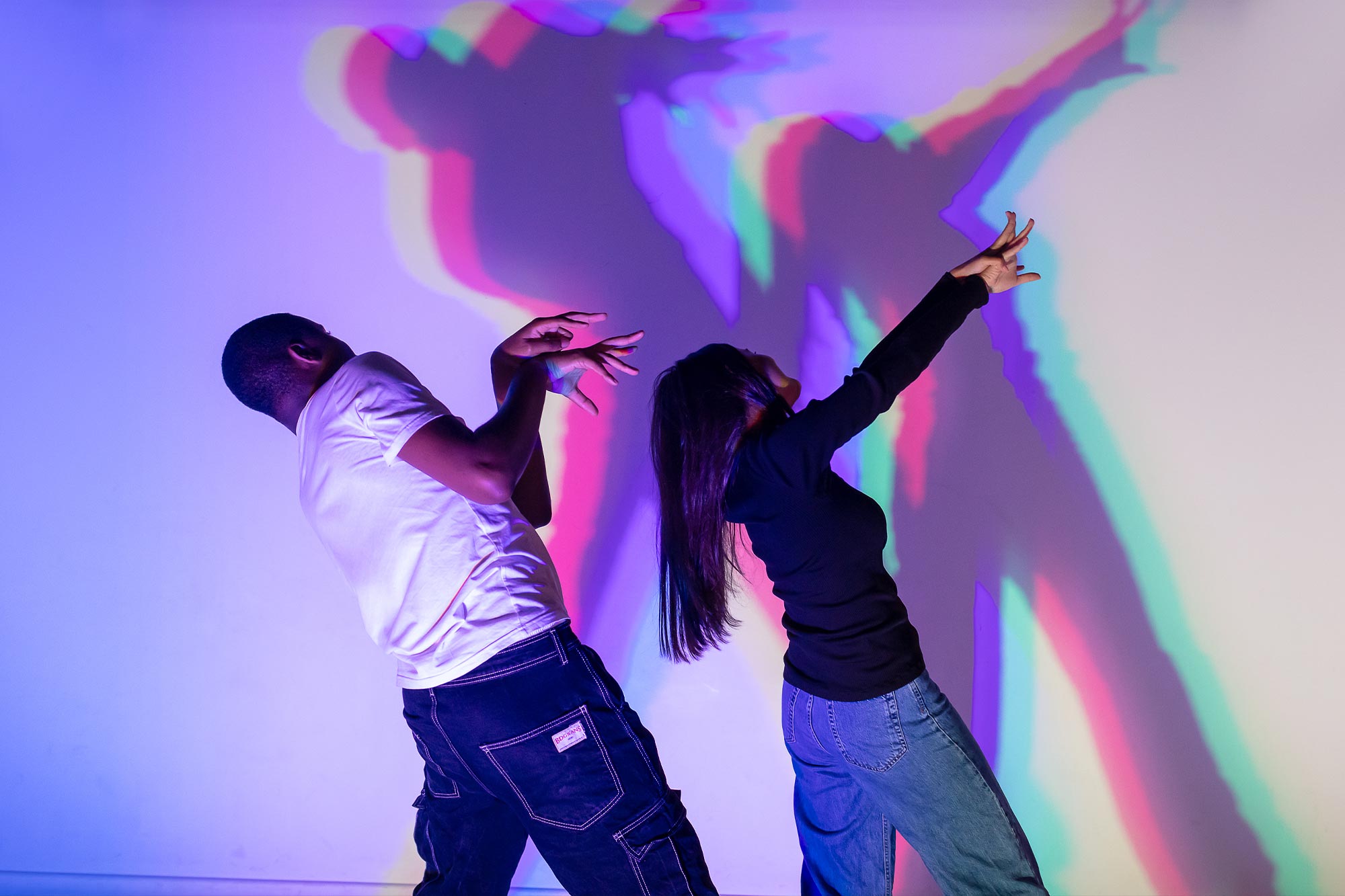 Two visitors enjoy the RGB wall at Twist Museum
